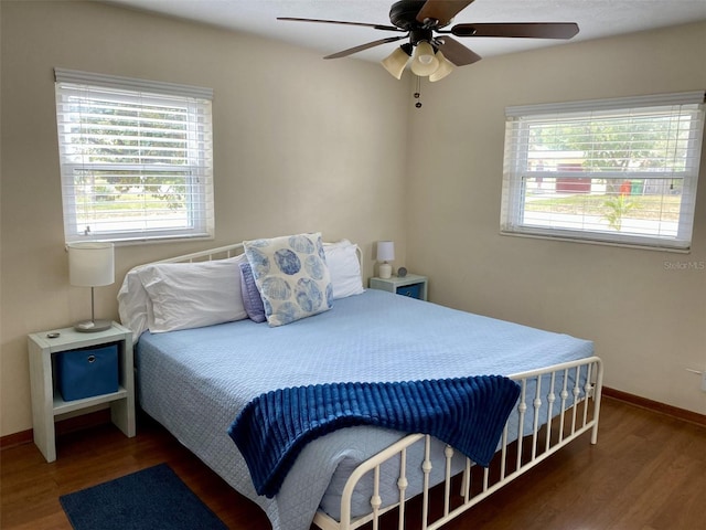 bedroom with dark wood-type flooring and ceiling fan