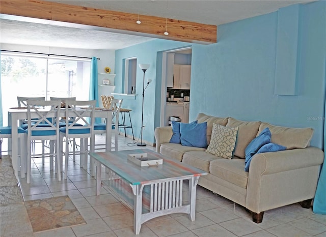 tiled living room featuring beamed ceiling