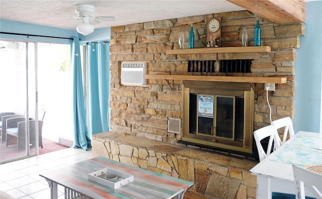 living room with tile patterned flooring, ceiling fan, and a textured ceiling