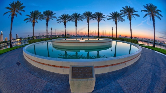 view of pool at dusk