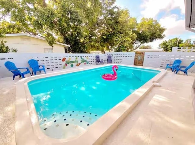 view of pool featuring fence