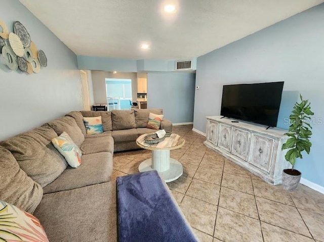 living room with visible vents, baseboards, and light tile patterned flooring