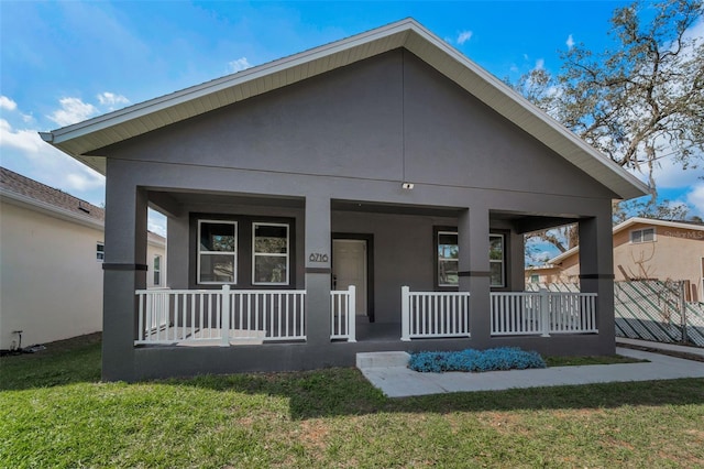 view of front of house with a porch and a front yard