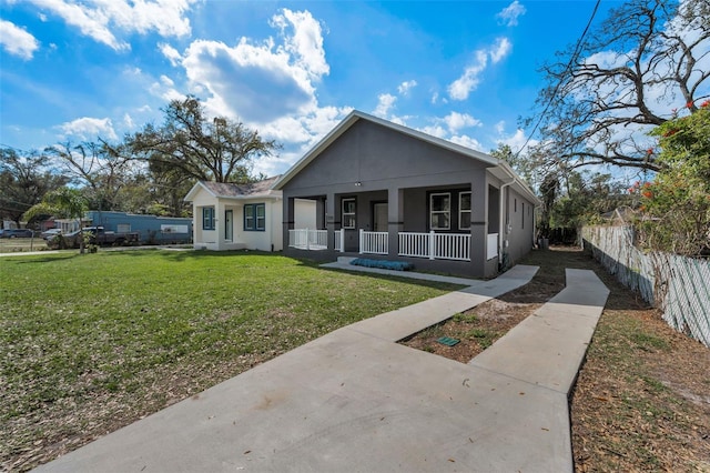 bungalow-style home featuring covered porch and a front lawn