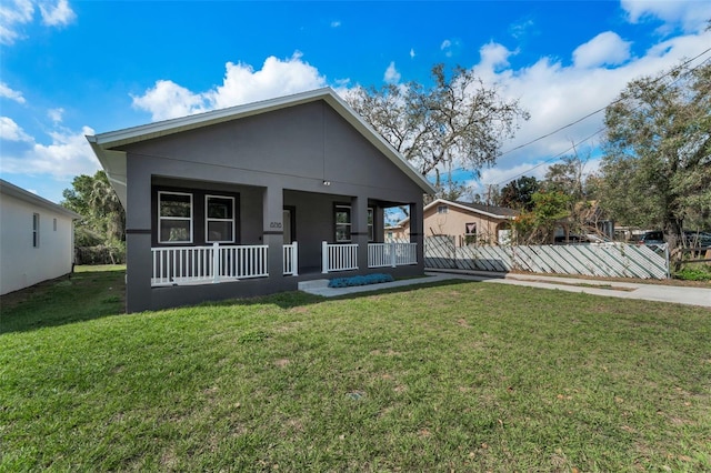 view of front of home with covered porch and a front lawn