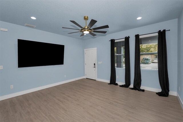 unfurnished room featuring hardwood / wood-style floors, a textured ceiling, and ceiling fan