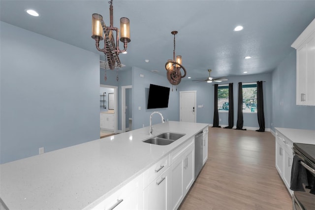 kitchen with sink, black electric range oven, white cabinetry, an island with sink, and light wood-type flooring