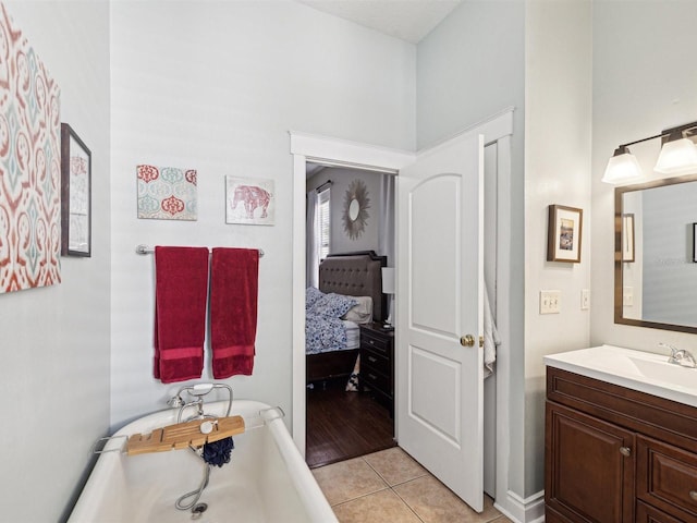 bathroom with vanity, tile patterned flooring, and a washtub