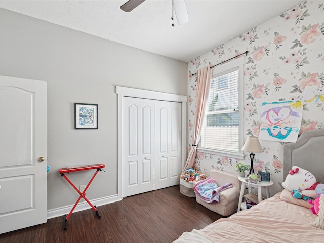 bedroom featuring a closet, dark hardwood / wood-style floors, and ceiling fan