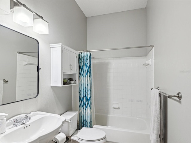 full bathroom with sink, toilet, and shower / bath combo with shower curtain