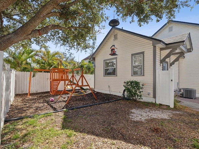 exterior space with central AC unit and a playground