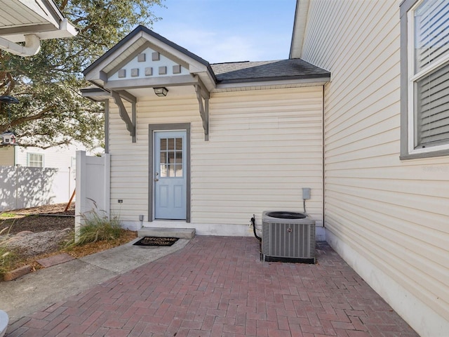 doorway to property with central AC unit and a patio area