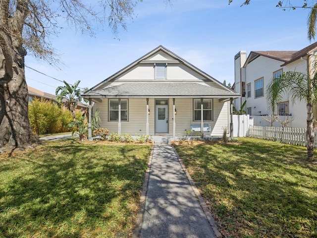 bungalow featuring a front lawn and a porch