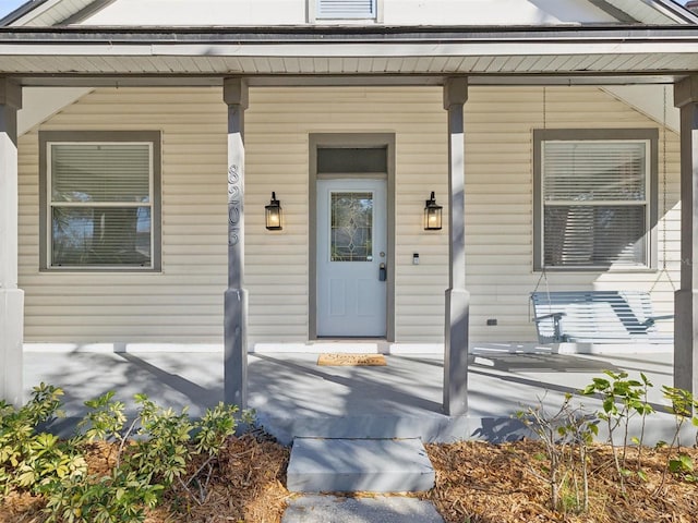 entrance to property featuring a porch