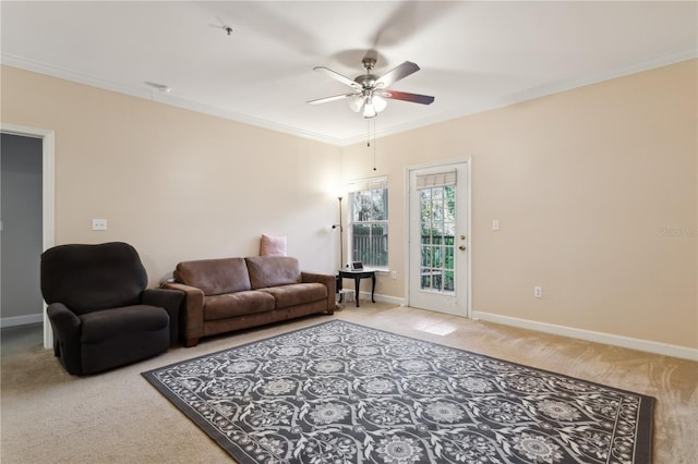 living room with crown molding, ceiling fan, and carpet flooring