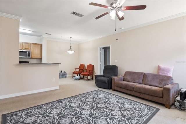 carpeted living room featuring crown molding and ceiling fan