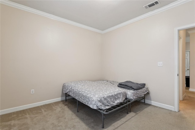 bedroom with crown molding and carpet