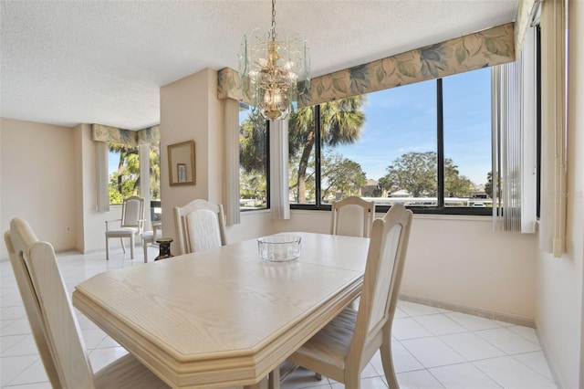 tiled dining room with a notable chandelier and a textured ceiling