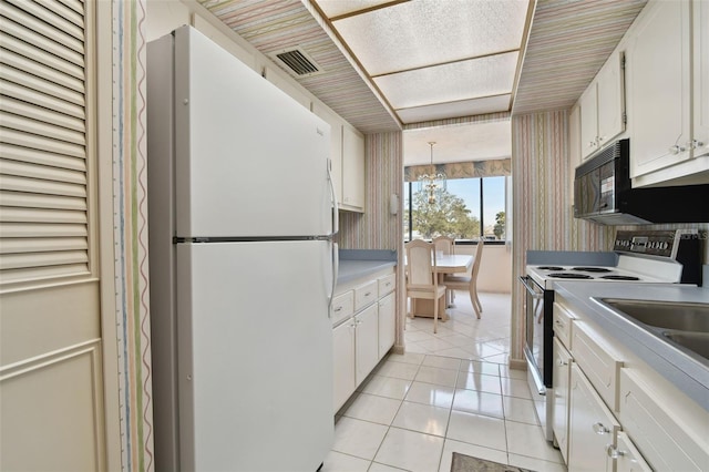 kitchen featuring white cabinetry, decorative light fixtures, electric range oven, light tile patterned floors, and white fridge