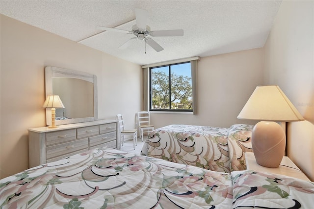 bedroom with ceiling fan and a textured ceiling