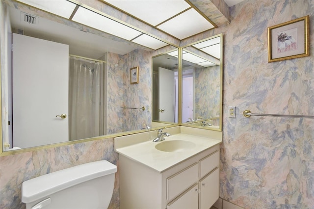 bathroom with vanity, a shower with curtain, and toilet