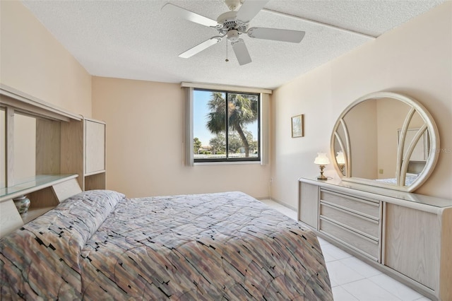 tiled bedroom featuring ceiling fan and a textured ceiling