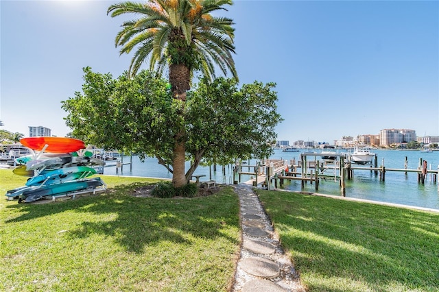 dock area featuring a water view and a yard