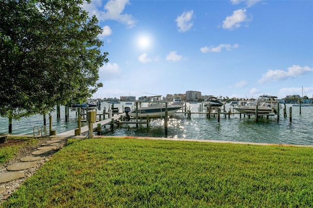 view of dock featuring a yard and a water view