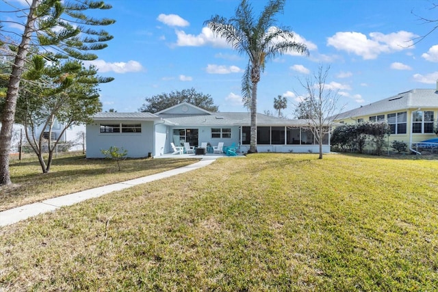 ranch-style home featuring a sunroom and a front yard