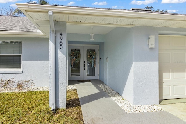 doorway to property with french doors and a garage