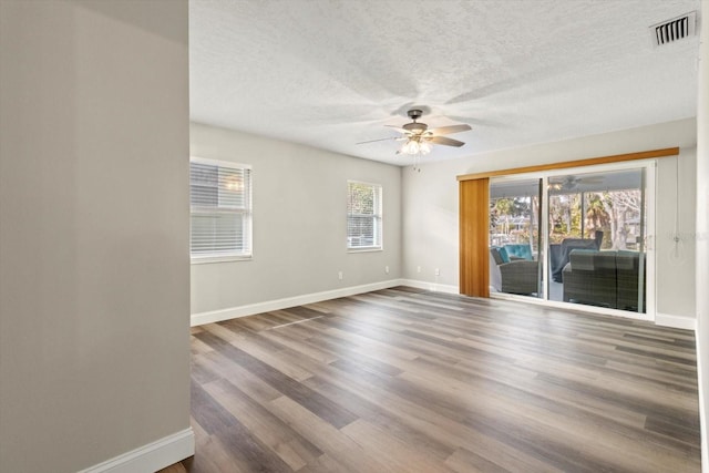 spare room with hardwood / wood-style flooring, a textured ceiling, and ceiling fan