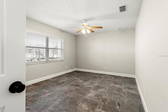 empty room featuring a textured ceiling and ceiling fan