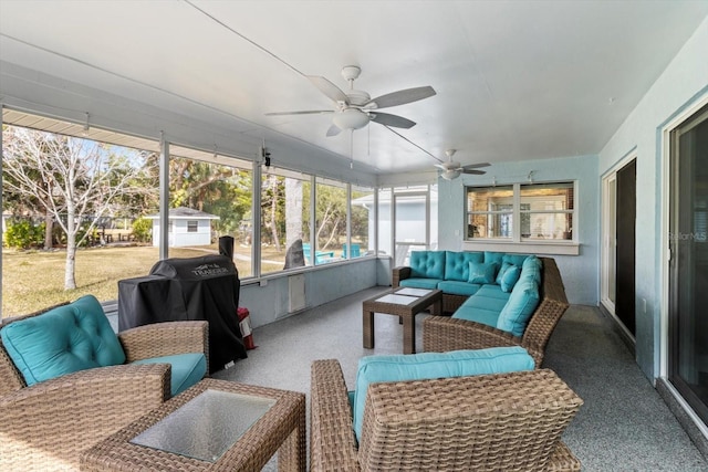 sunroom featuring ceiling fan