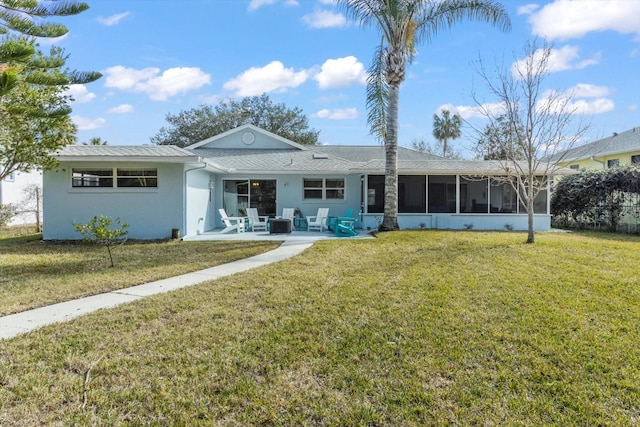 back of house featuring a sunroom, a patio area, and a lawn