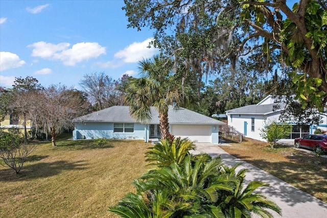 single story home featuring a garage and a front yard