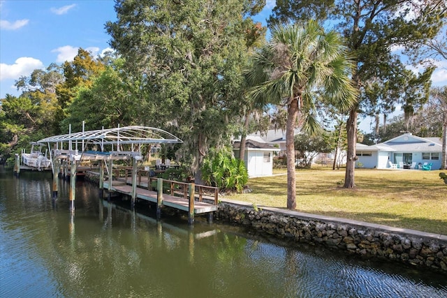 dock area featuring a water view and a lawn