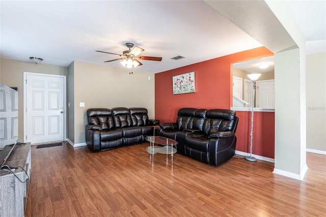 living room featuring ceiling fan and hardwood / wood-style floors