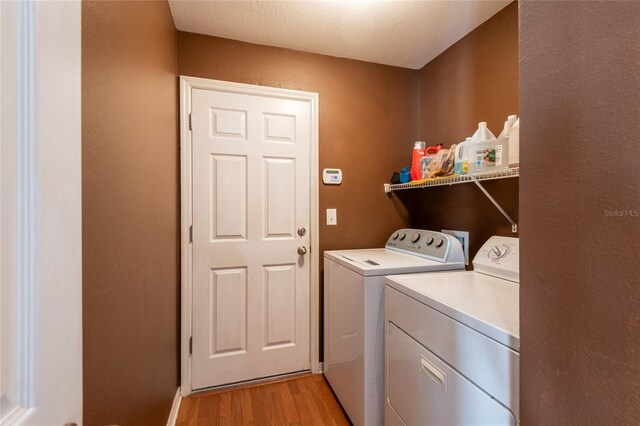 laundry area featuring independent washer and dryer and light wood-type flooring