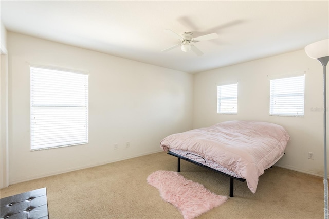 bedroom with light carpet and ceiling fan