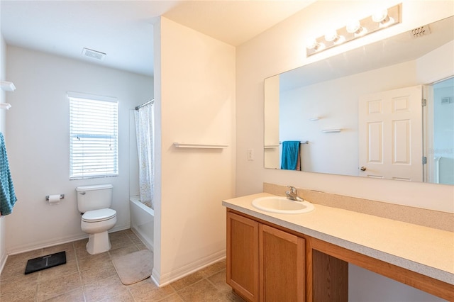 full bathroom featuring tile patterned flooring, vanity, toilet, and shower / bath combo with shower curtain