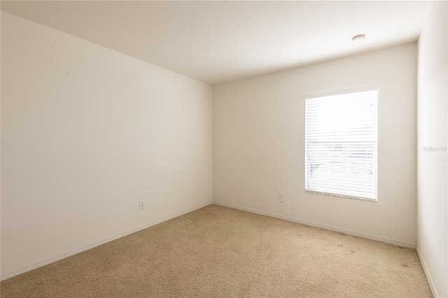 unfurnished room featuring light colored carpet