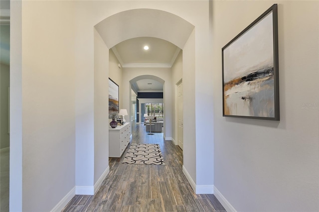 hall with crown molding and dark wood-type flooring