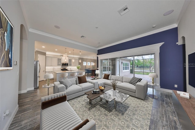 living room featuring crown molding and dark wood-type flooring