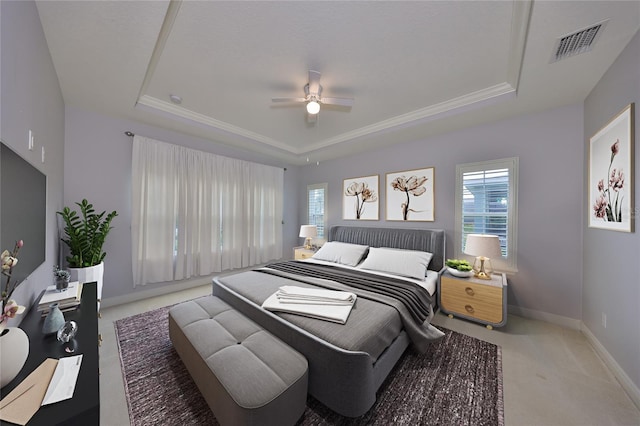 bedroom featuring a tray ceiling, ceiling fan, and carpet flooring