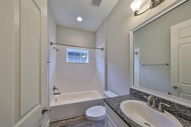 full bathroom featuring hardwood / wood-style flooring, bathing tub / shower combination, vanity, and toilet