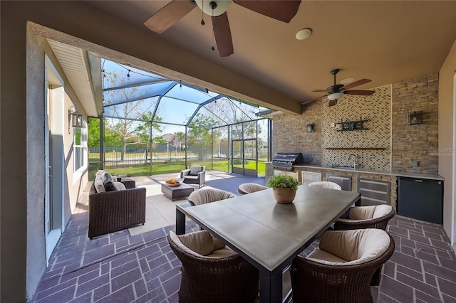 view of patio with exterior kitchen, outdoor lounge area, sink, and grilling area