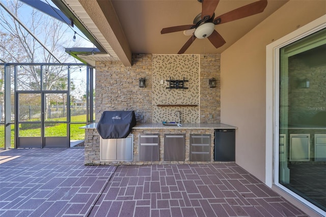 view of patio / terrace featuring exterior kitchen, grilling area, sink, and ceiling fan