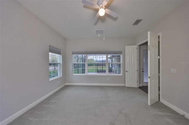 unfurnished bedroom with light carpet and ceiling fan