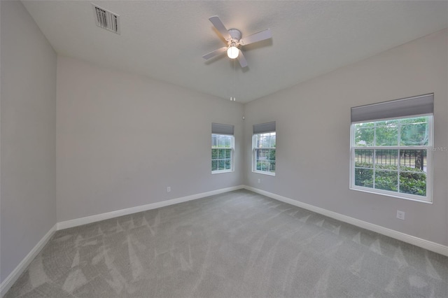 carpeted spare room with ceiling fan