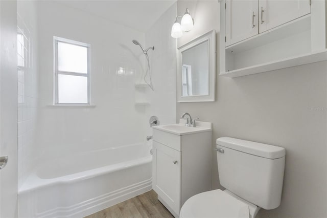 full bathroom featuring hardwood / wood-style flooring, vanity, toilet, and shower / bathing tub combination